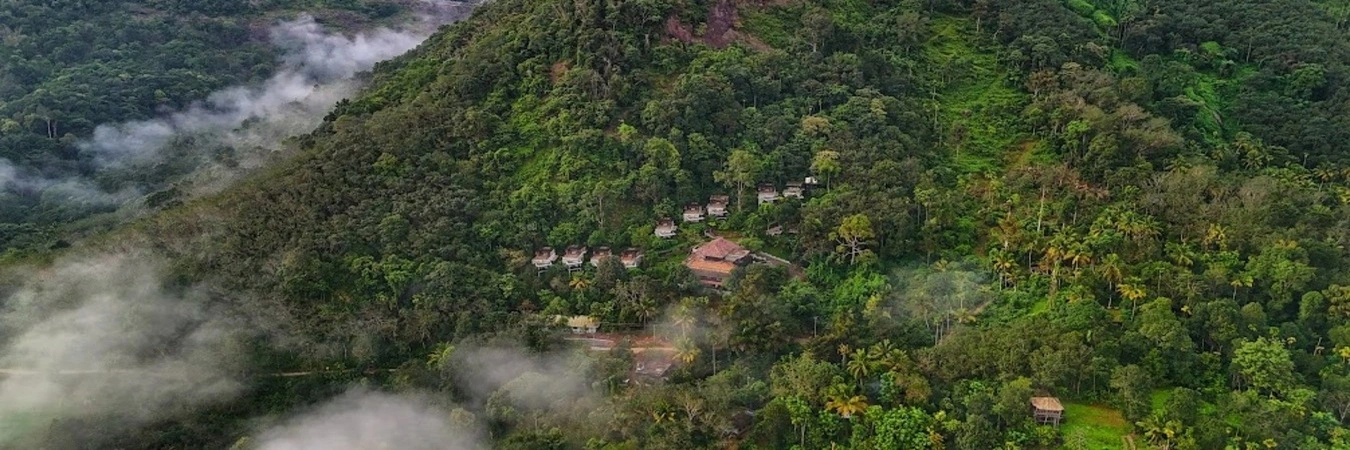 Aerial view of Mountree Munnar luxury resort nestled amidst green mountain landscapes