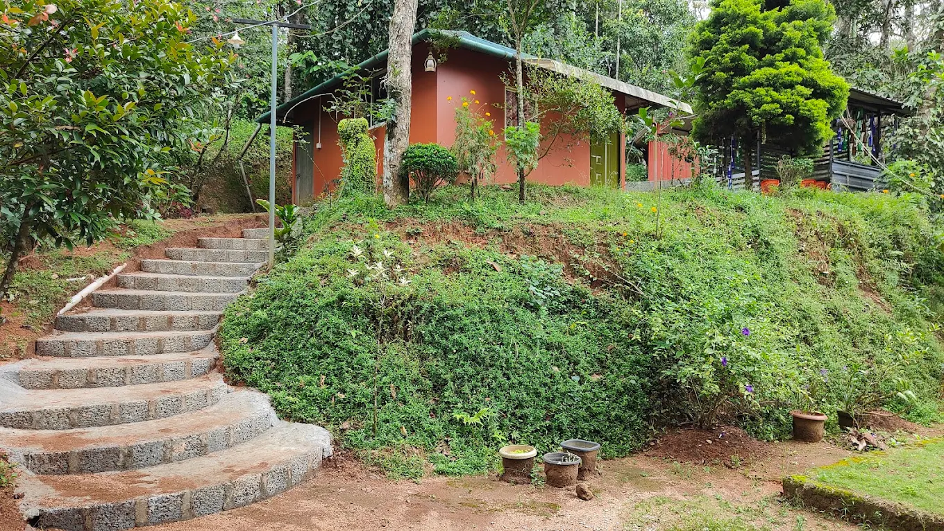 Pepper County Farm Stay cottage with stone steps surrounded by greenery in Munnar