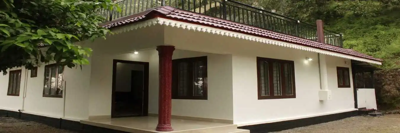 Exterior front view of Valley Homestay bungalow property featuring a red-tiled roof in Bison Valley.