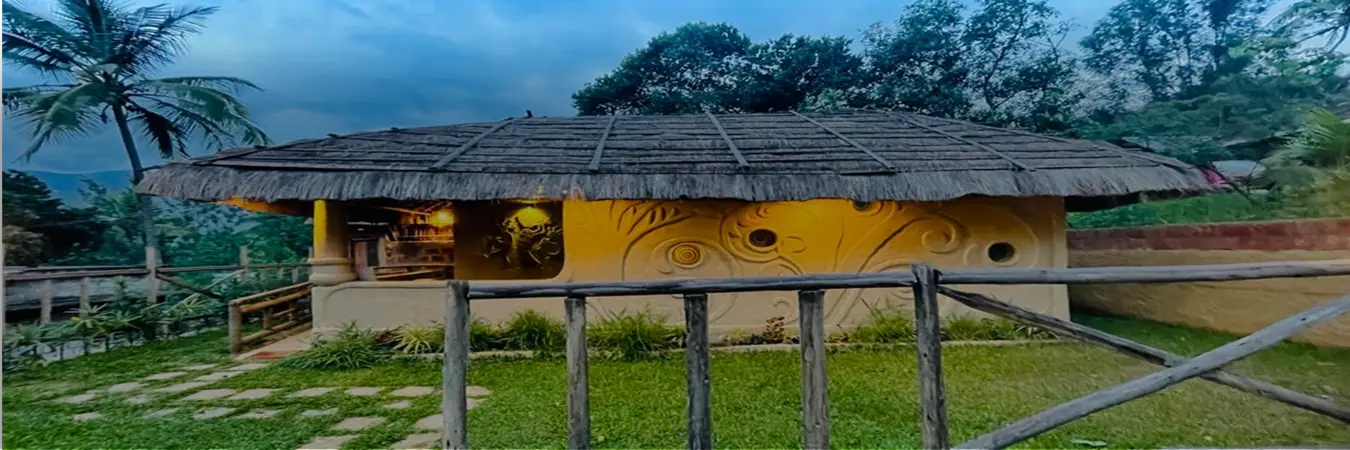 Exterior view of the eco-friendly Earthen Pool Villa cottage building in Marayoor near Munnar