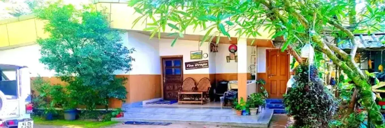 Munnar Homestay Teadrops Plantation Villa cottage exterior featuring private balcony and garden entry