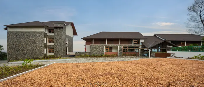 Olive Woods luxury nature resort with stone architecture and mountain views.