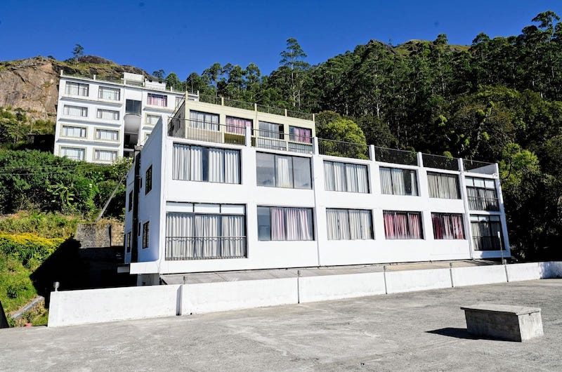 Exterior View of The Vue Munnar Retreat Resort in Munnar Surrounded by Misty Green Hills
