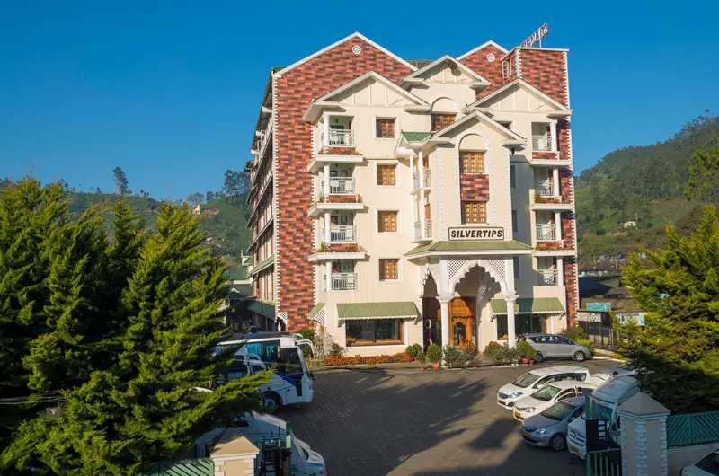 Exterior View of The Sivertips Hotels in Munnar Surrounded by Misty Green Hills