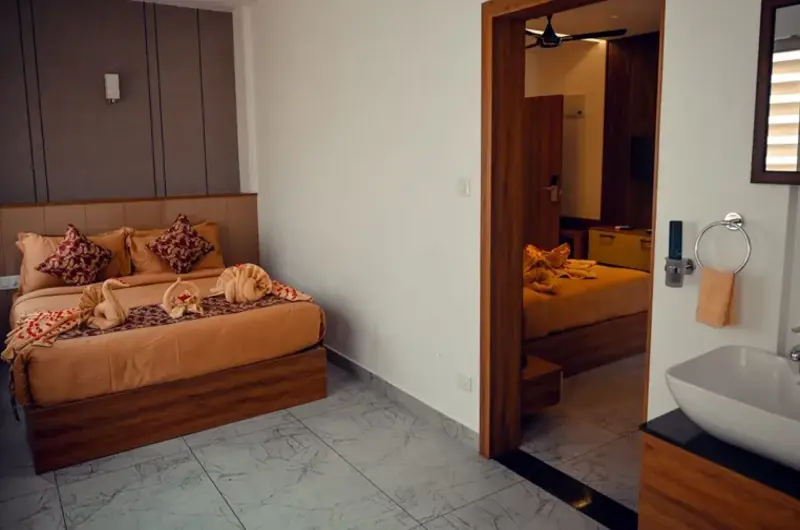 Cozy hotel room suite featuring comfortable bedding and modern interior design at Boulevard Hotel Munnar