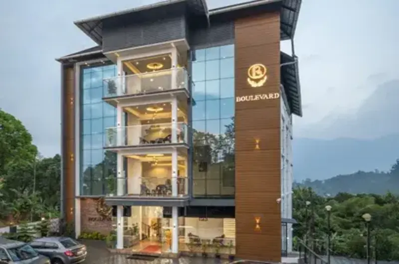 Modern exterior facade of Boulevard Hotel Munnar building surrounded by trees