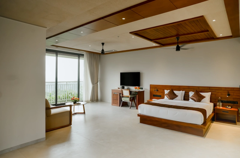 Spacious guest room bedroom setup with ambient lighting at Mountree Munnar