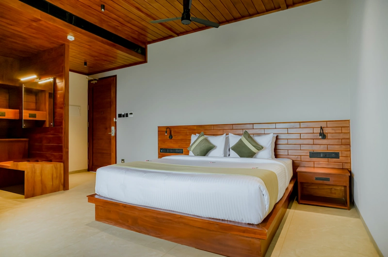 Elegantly designed resort room interior with king size bed at Mountree Munnar