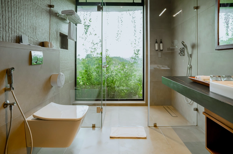 Luxury resort bathroom with wash basin and modern bath amenities at Mountree Munnar