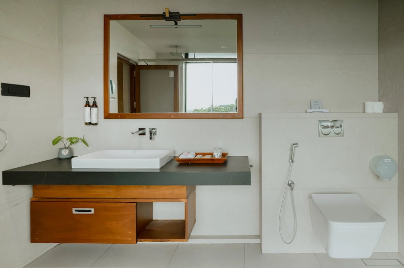 Clean modern resort bathroom design with premium fixtures at Mountree Munnar