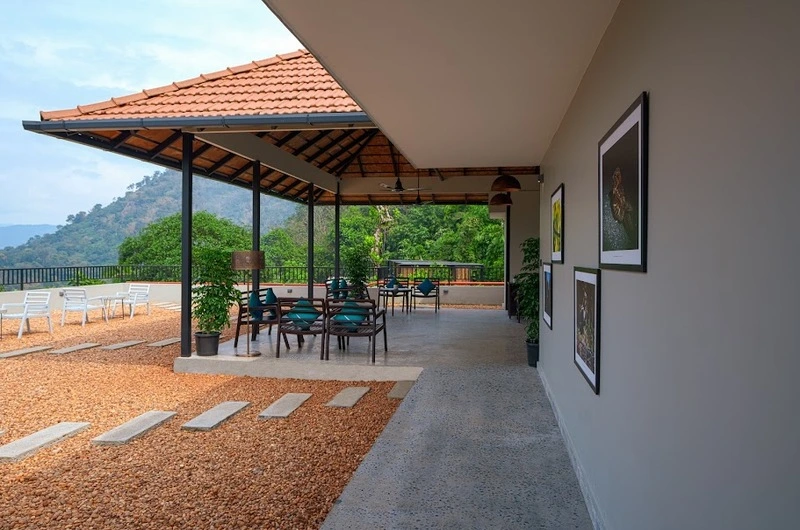 Spacious open-air balcony veranda overlooking green nature hills at Maram Resort Mamalakandam