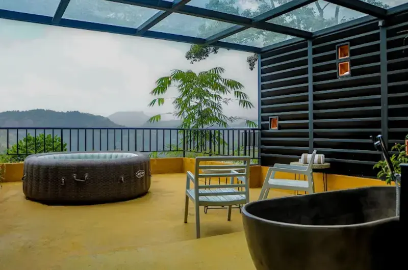 Infinity swimming pool overlooking lush green forest at Maram Resort Mamalakandam