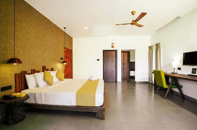 Spacious resort bedroom interior with modern amenities at Maram Resort Mamalakandam