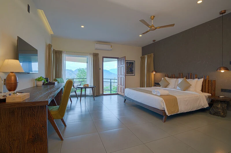 Resort room suite featuring large glass balcony window at Maram Resort Mamalakandam