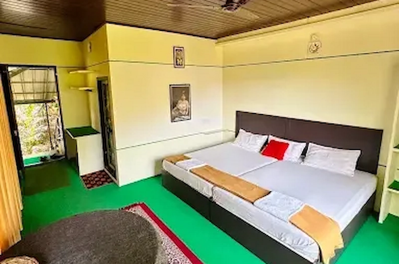 Spacious bedroom with wooden ceiling and double bed at Thoppil Homestay Munnar