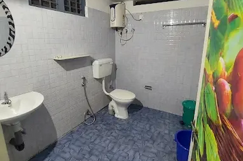 Clean attached bathroom with shower at Thoppil Homestay Munnar
