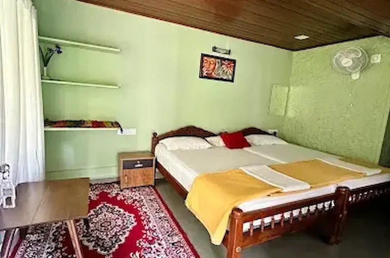 Cozy guest bedroom interior with comfortable bed at Thoppil Homestay