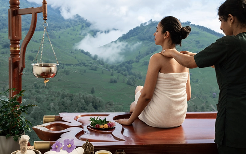 Outdoor wellness spa massage session with mountain view at 1924 Clock House Resort Munnar