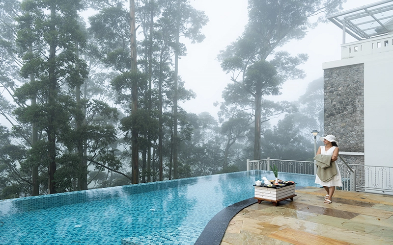 Covered glass-roof swimming pool deck with scenic mountain view at 1924 Clock House Resort