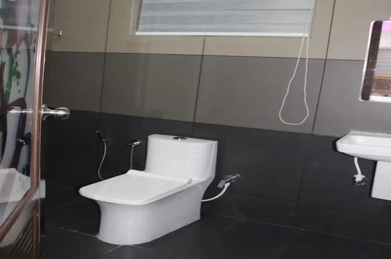Clean and modern ensuite guest bathroom facilities at 4 Acre Woods Farm Stay Munnar