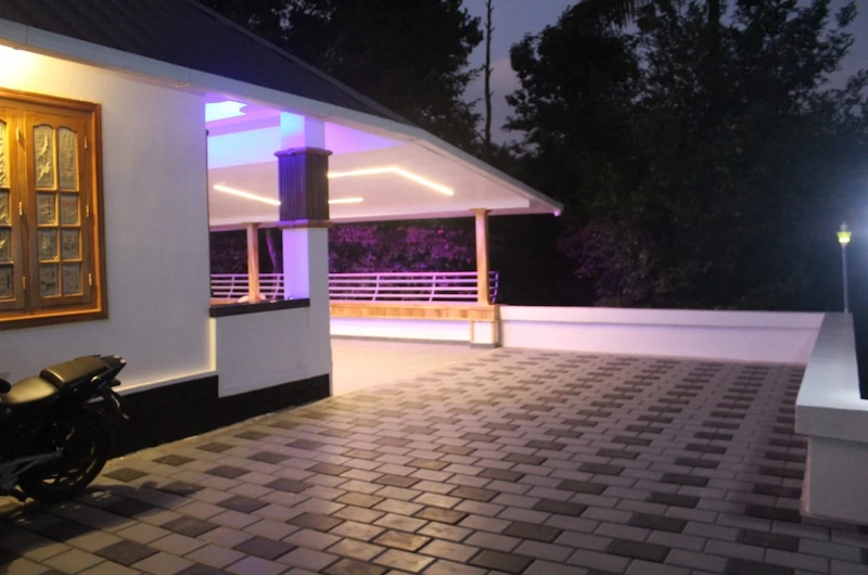 Warmly lit cottage interior entrance at night at 4 Acre Woods Farm Stay Munnar