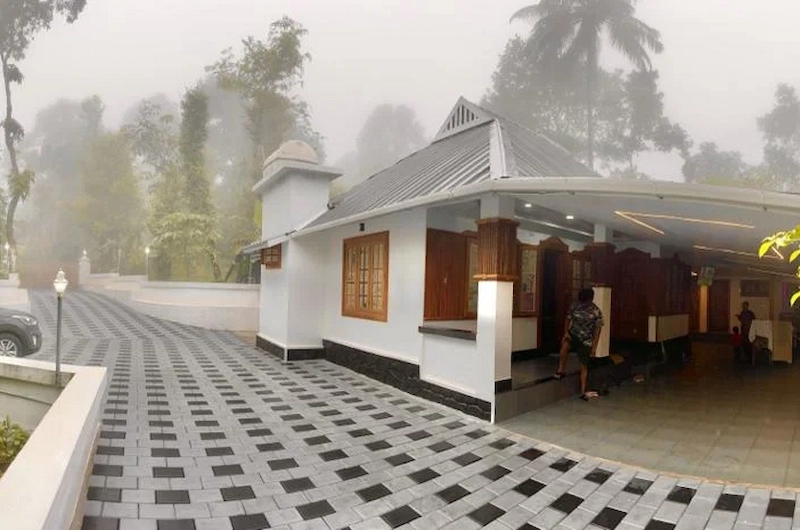 Front entrance and paved courtyard of cottage resort at 4 Acre Woods Farm Stay Munnar