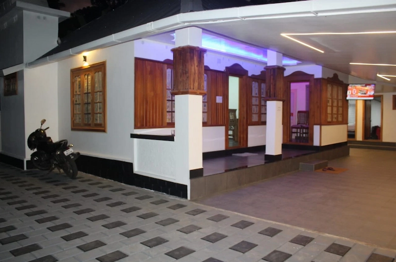 Spacious covered veranda patio with seating area at 4 Acre Woods Farm Stay Munnar