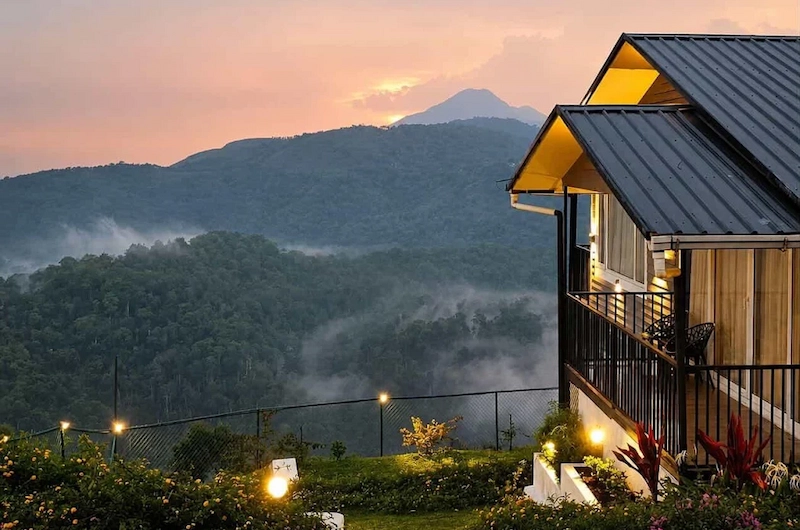 Cozy wooden cottage cottage illuminated at twilight on hillside at Wild Lilly