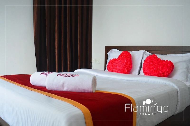 Honeymoon bedroom suite with decorative heart pillows at Flamingo Resort Munnar