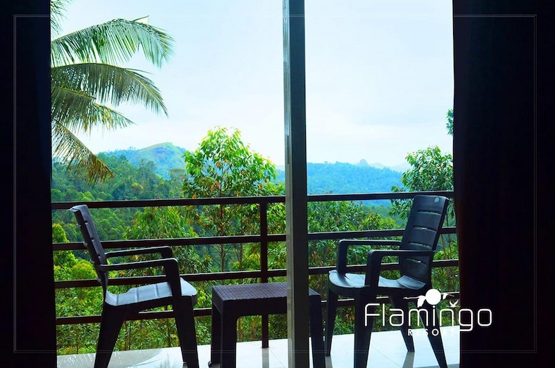 Private room balcony chairs offering scenic mountain views at Flamingo Resort Munnar