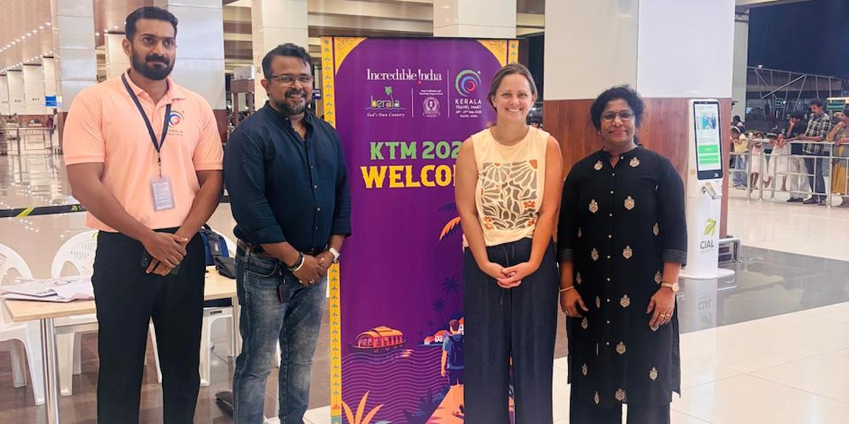 Kerala Travel Mart 2026 welcome committee standing at event registration counter in Kochi