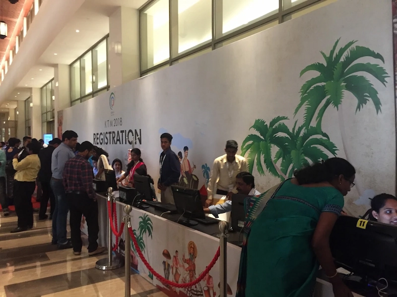 Attendees queuing at registration desks inside venue of Kerala Travel Mart Kochi
